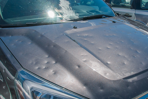 Dented car after a big hail storm | Harvs Auto Body Repair in Iowa City