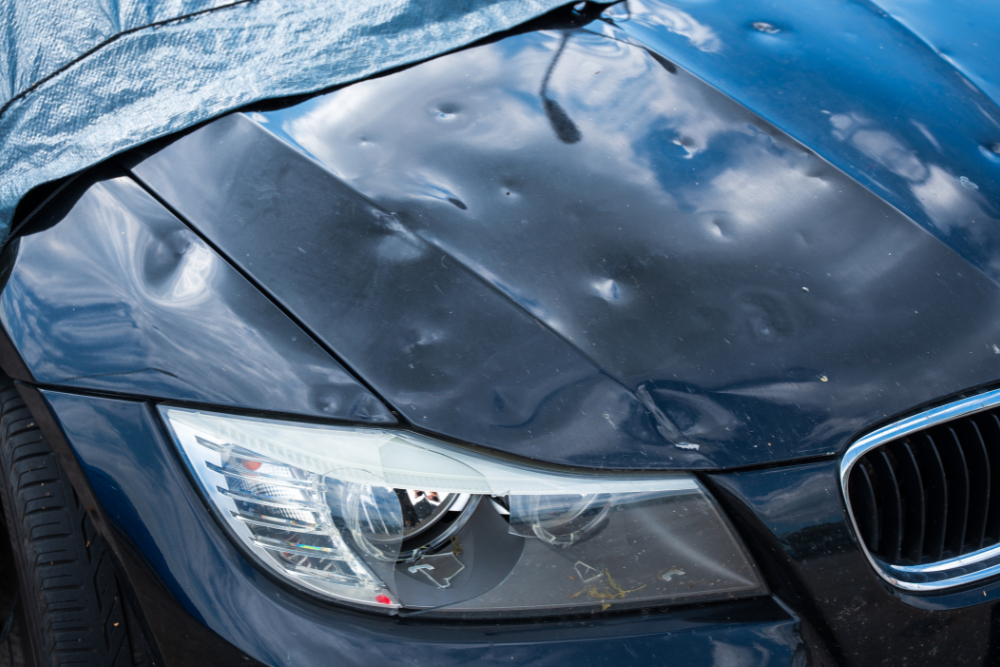 Paintless Dent Repair in Iowa City, IA At Harv’s Auto Body Repair. Image of severe hail damage dents on a car hood